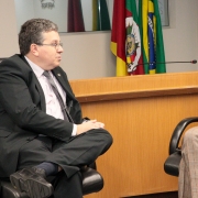 a esquerda da foto, defensor público-geral está sentado e olhando para Luciana Luso de Carvalho, que está a direita da foto e sentada de frente para ele