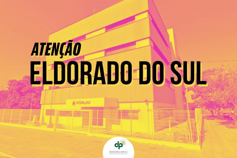 Cartaz escrito: atenção Eldorado do Sul, imagem do fórum do Município aparece aos fundos. 