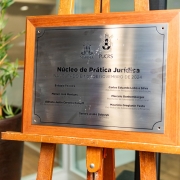 Placa de inauguração escrito "núcleo de prática jurídica".